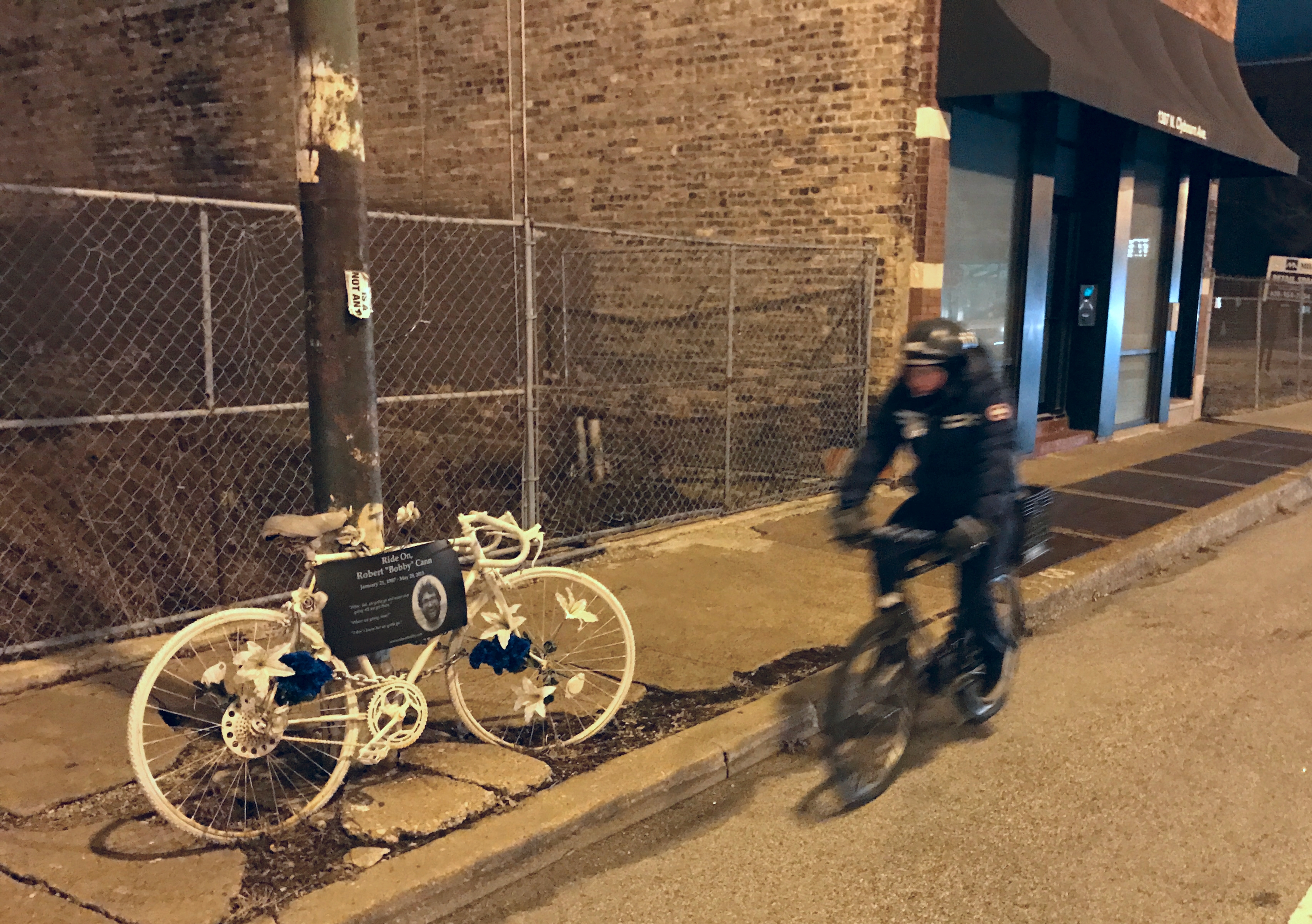 A man rides by the ghost bike memorial to Bobby Cann on Clybourn last night. Photo: John Greenfield