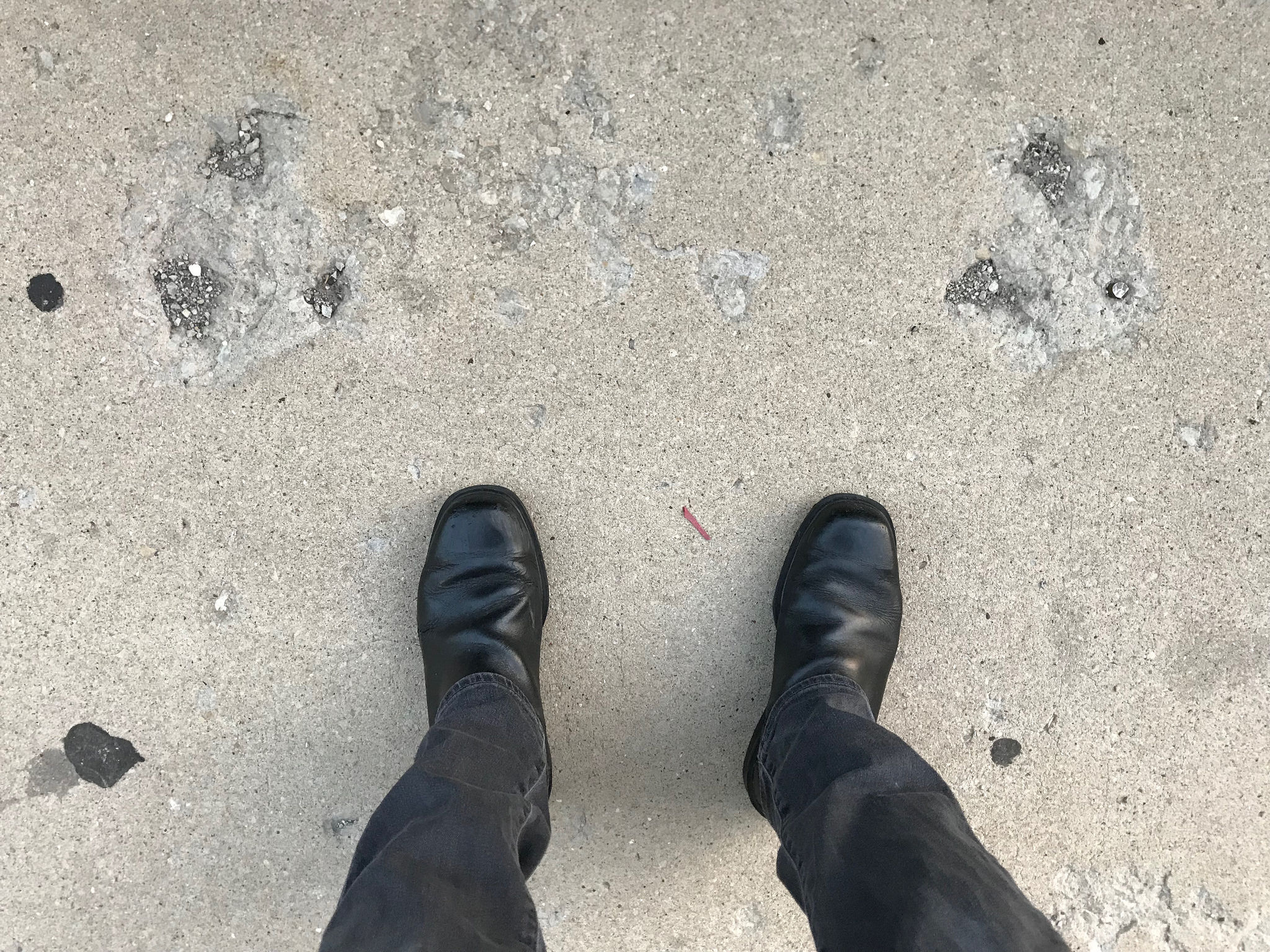Scars in the sidewalk in front of the 32nd Ward service office, where a driver took out a bike rack. Photo: John Greenfield