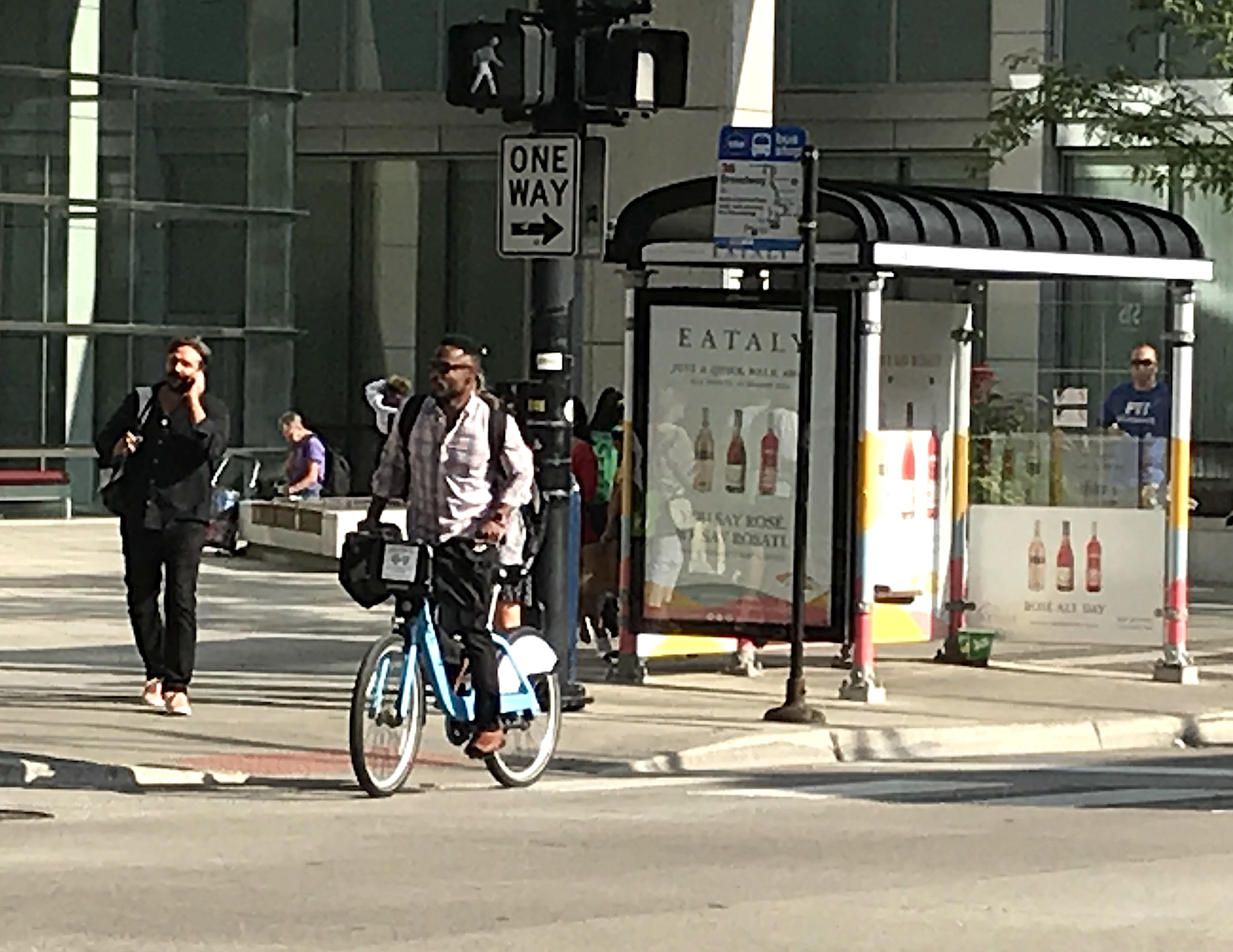 A man rides a Divvy in River North, where a Black bike advocate claims police have been racial profiling Divvy users. Photo: John Greenfield