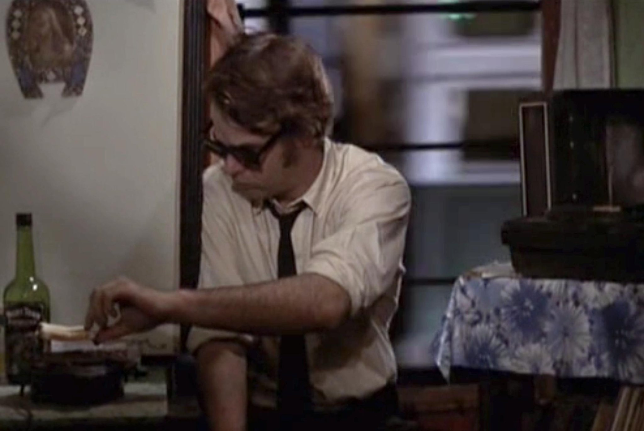 Dan Akroyd as Jake Blues in his 'L'-adjacent SRO room.