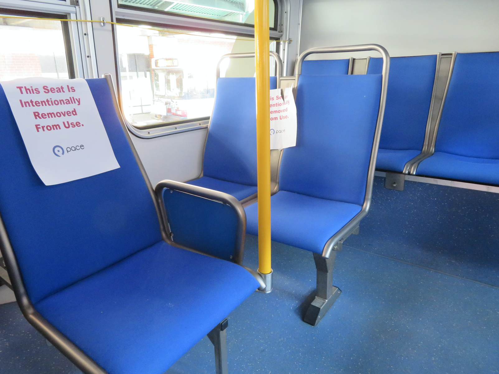 Signs posted on Pace bus seats to encourage social distancing. Photo: Jeff Zoline