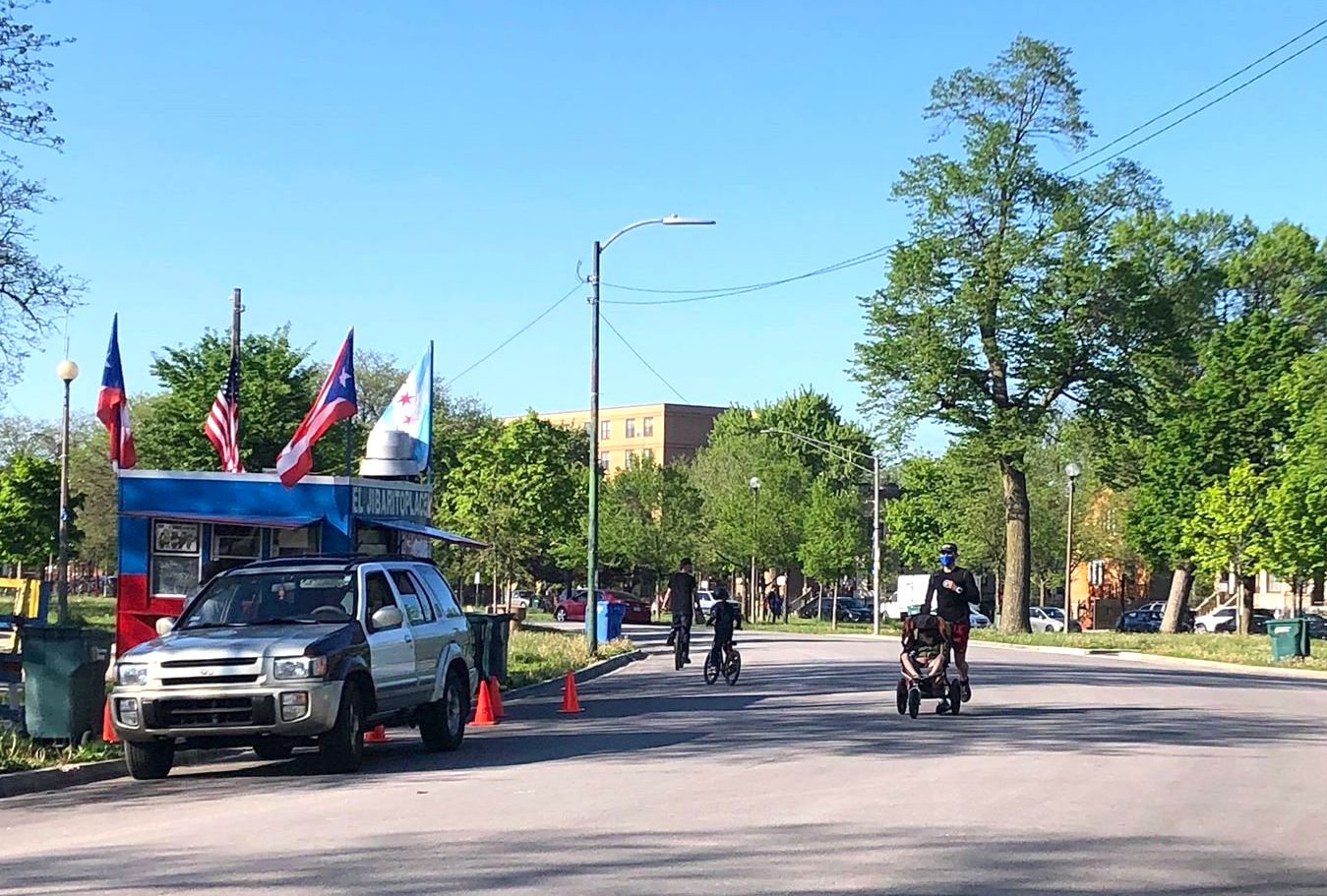 Families cycling and strolling pass by one of Humboldt Park's many Puerto Rican food trucks. Photo: Stephanie Reid