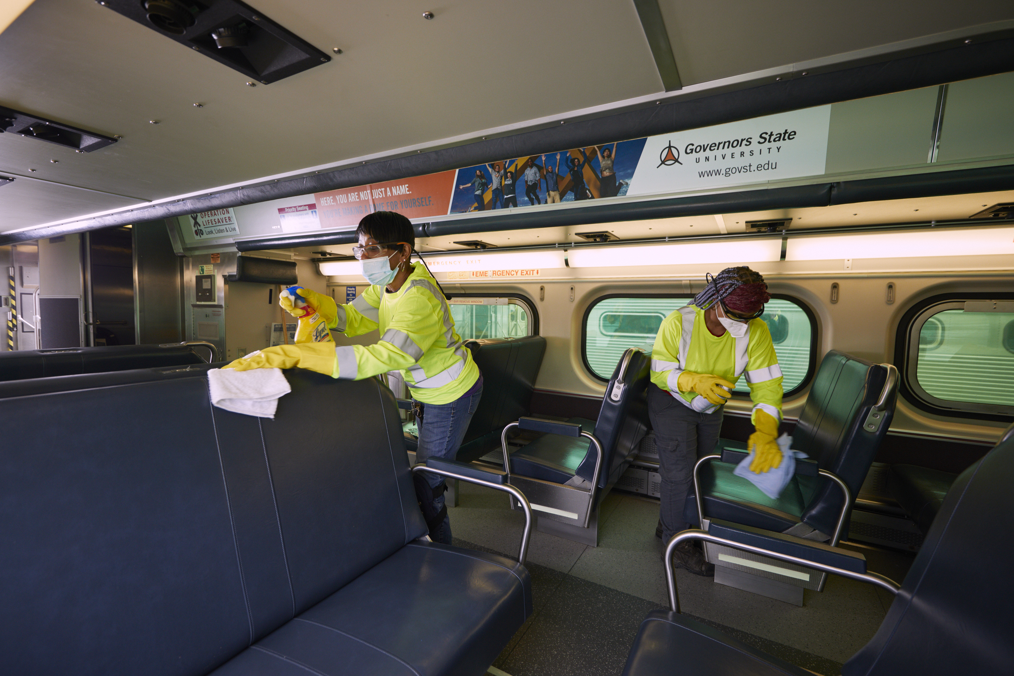 Metra workers clean seats in a rail carriage. Photo: Meta