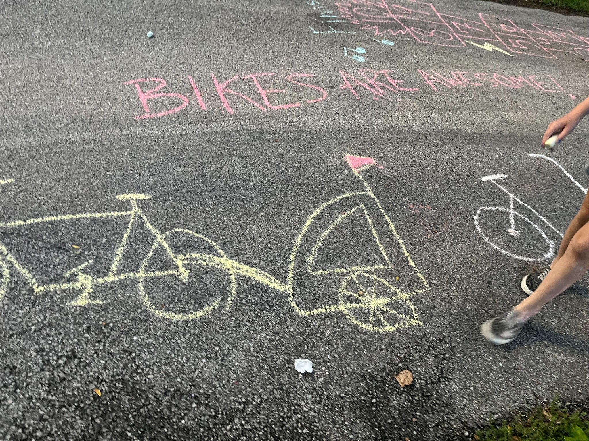 A chalk drawing of a bike with a trailer attached and "Bikes are Awesome" on a street during a recent bike jamPhoto: Chicago Family Biking