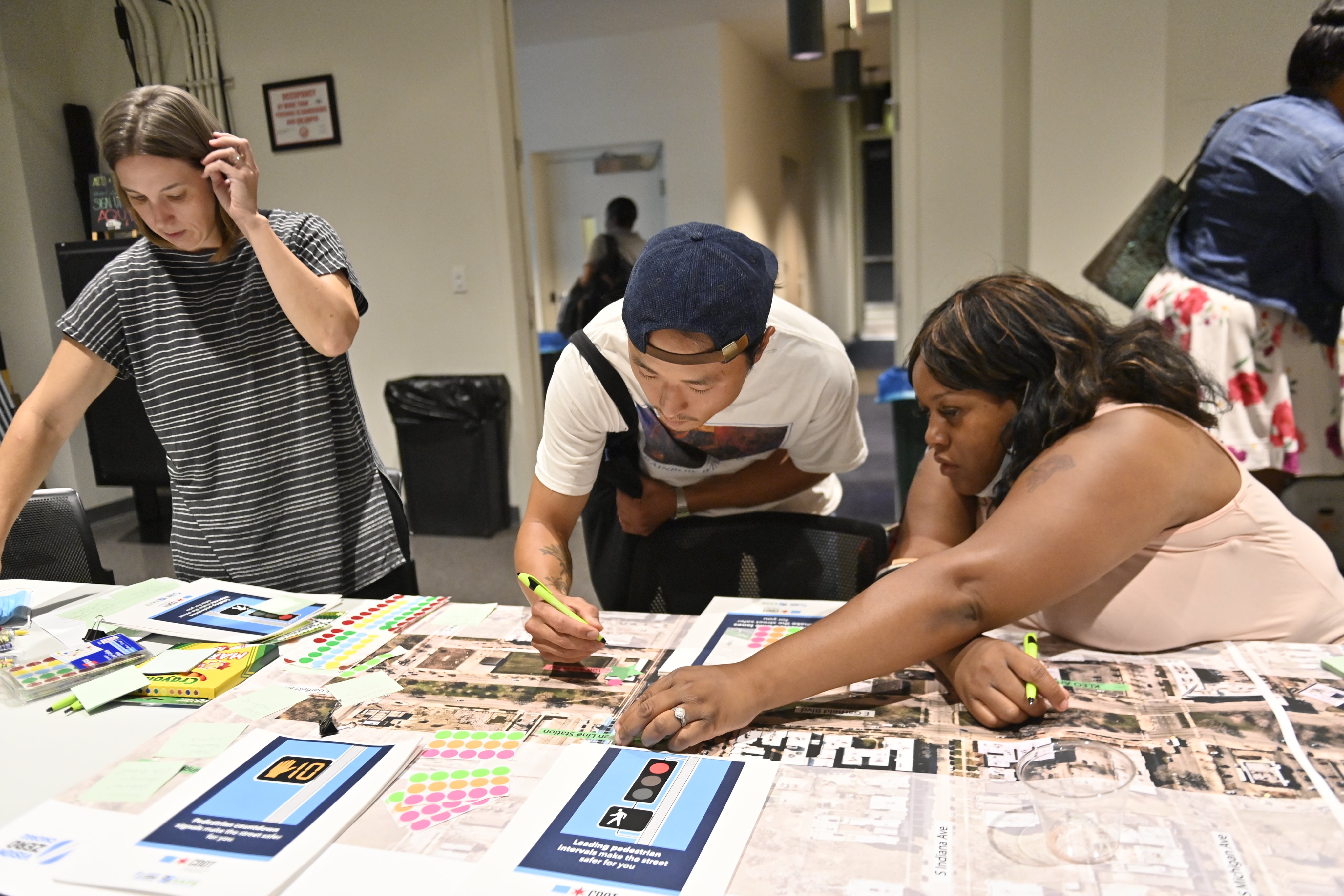 Attendees write out feedback for safety improvements to pin to a map of Garfield BoulevardPhoto" CDOT