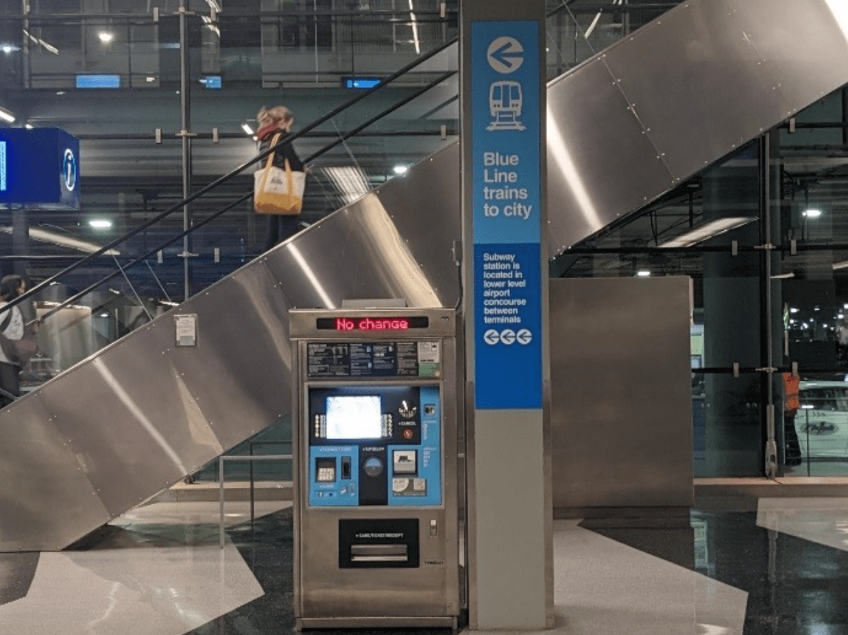 A sign on a pillar in the airport pointing the way to the train station. Photo: CTA