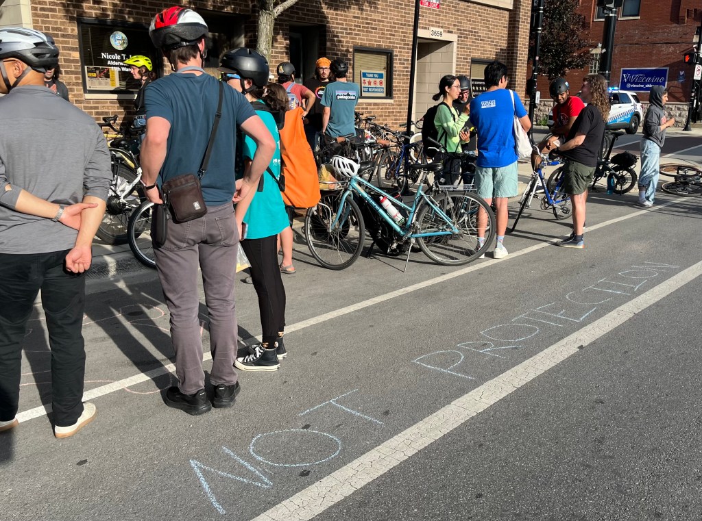 Complete Streets planner Riley O’Neil died in a paint-only bike lane. Protesters demand we value people over parking.